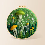 Whimsical green and yellow jellyfish needle felting kit for beginners with a round wooden frame