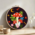 Whimsical mushroom punch needle artwork displayed on a table