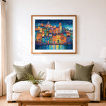 Finished whimsical night harbor town cross stitch artwork displayed as home decor