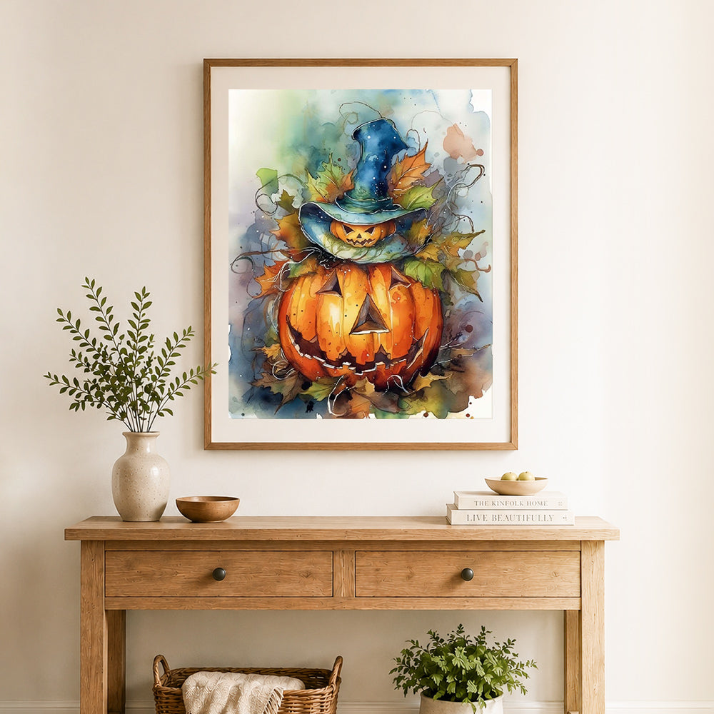 Finished whimsical watercolor pumpkin cross stitch artwork displayed as home decor