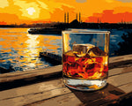 Whiskey glass on wooden pier at sunset cross stitch kit for beginners