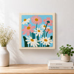 Finished white and pink daisies artwork displayed on a wall