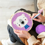 Creating handmade white bear in purple background punch needle artwork