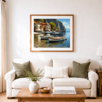 Finished white boats moored in cliffside mediterranean village cross stitch artwork displayed as home decor