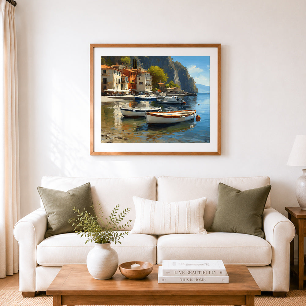 Finished white boats moored in cliffside mediterranean village cross stitch artwork displayed as home decor