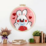 Finished white bunny with hearts artwork displayed on a wall