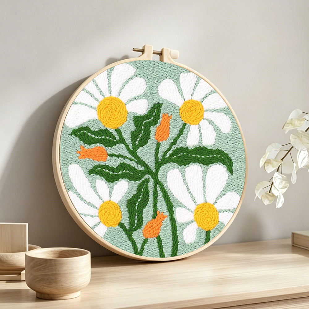 White chamomile punch needle artwork displayed on a table