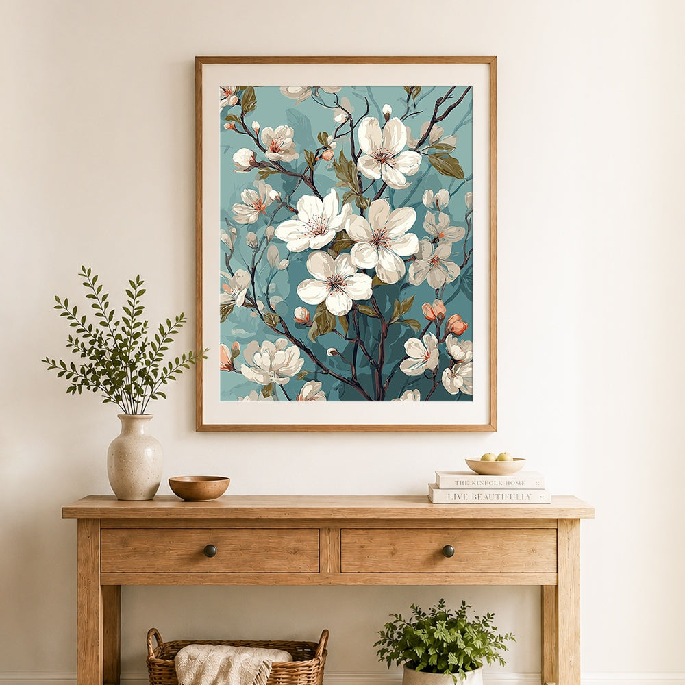 Finished white cherry blossom branch cross stitch artwork displayed as home decor