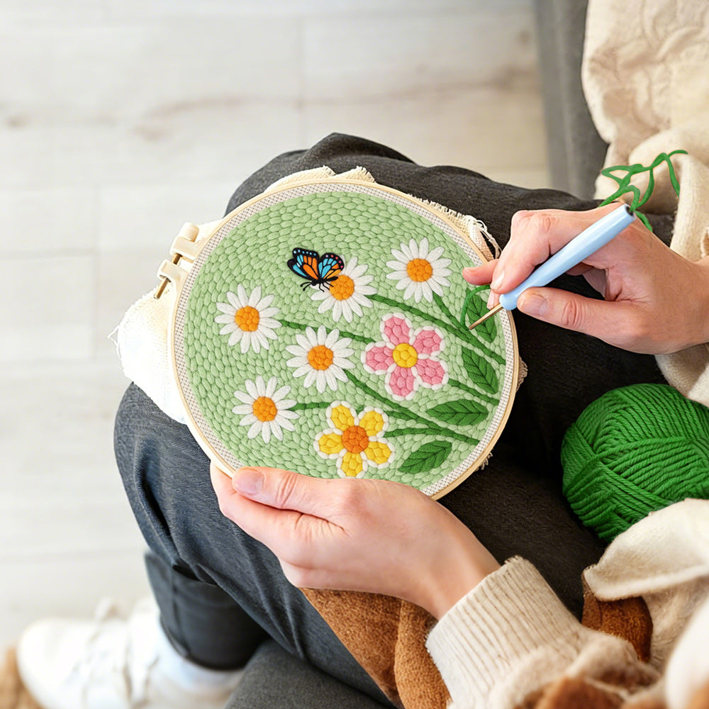 Creating handmade white daisies and butterfly punch needle artwork