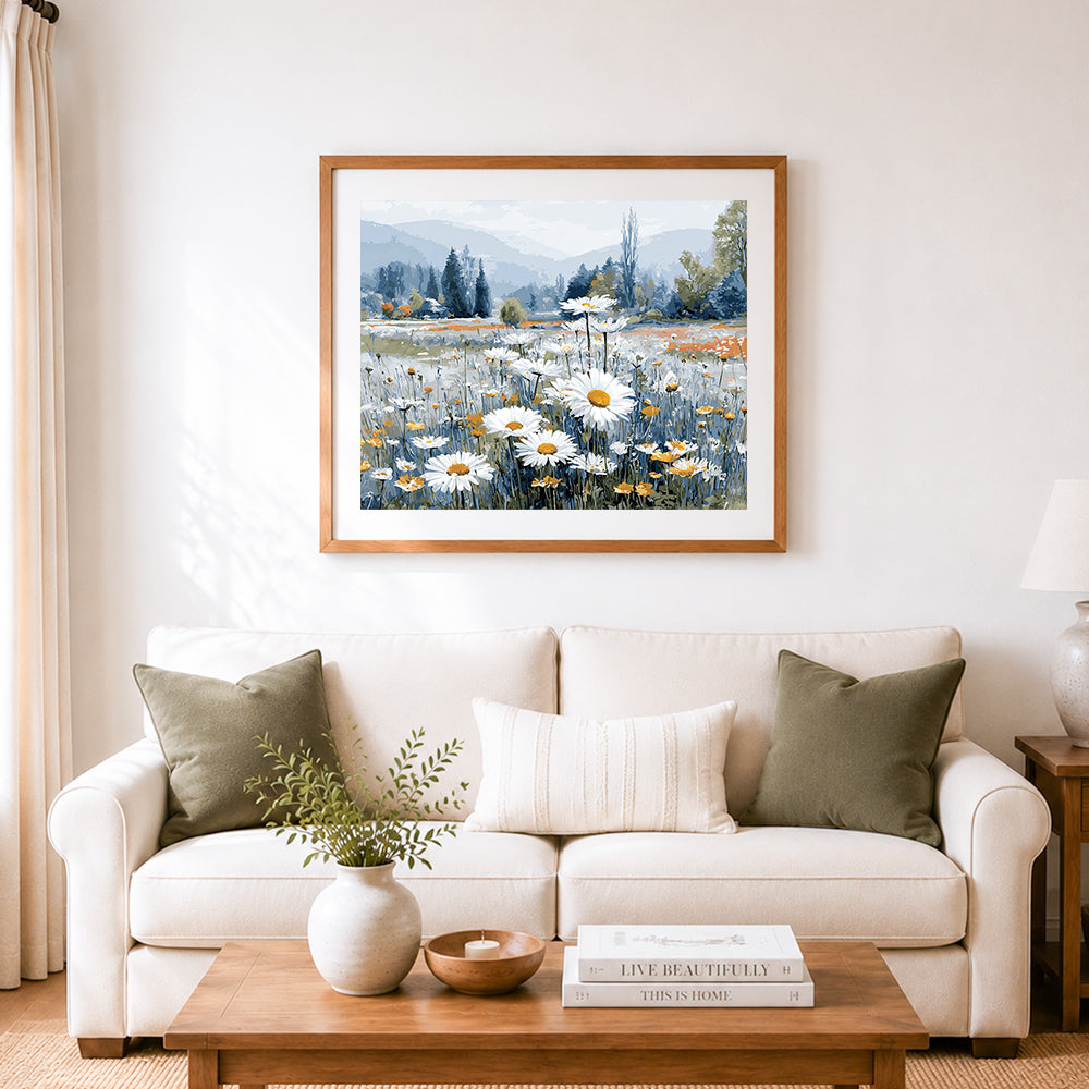 Finished white daisies in a blue mountain field cross stitch artwork displayed as home decor