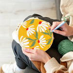 Creating handmade white daisies on a yellow background punch needle artwork