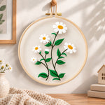 White daisies with green leaves embroidery hoop wall art displayed as warm and cozy handmade home decor