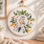 White daisy cluster and letter q embroidery hoop wall art displayed as warm and cozy handmade home decor