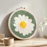 White daisy flower punch needle artwork displayed on a table