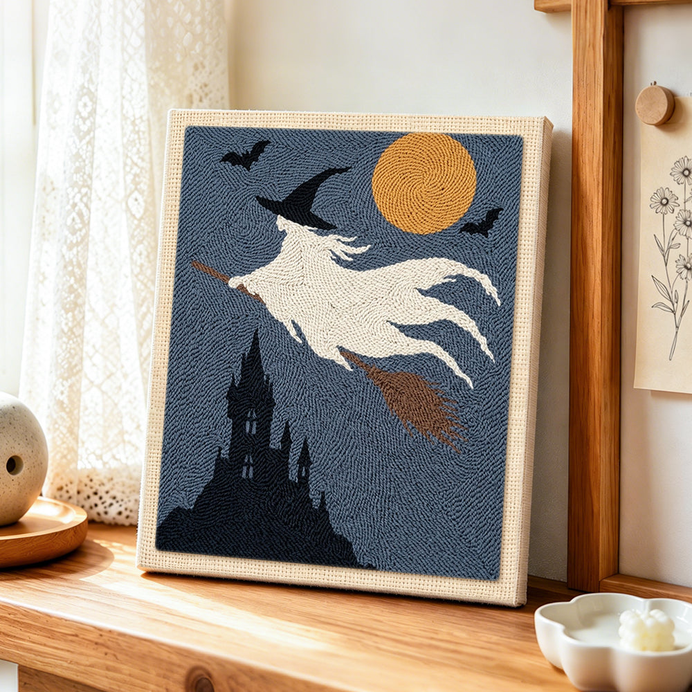 White ghost witch punch needle artwork displayed on a table