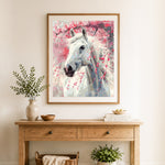 Finished white horse with cherry blossoms cross stitch artwork displayed as home decor