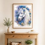 Finished white horse with wild blooms cross stitch artwork displayed as home decor