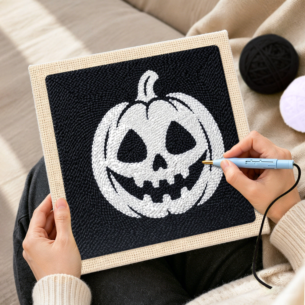 Creating handmade white jack‑o‑lantern punch needle artwork