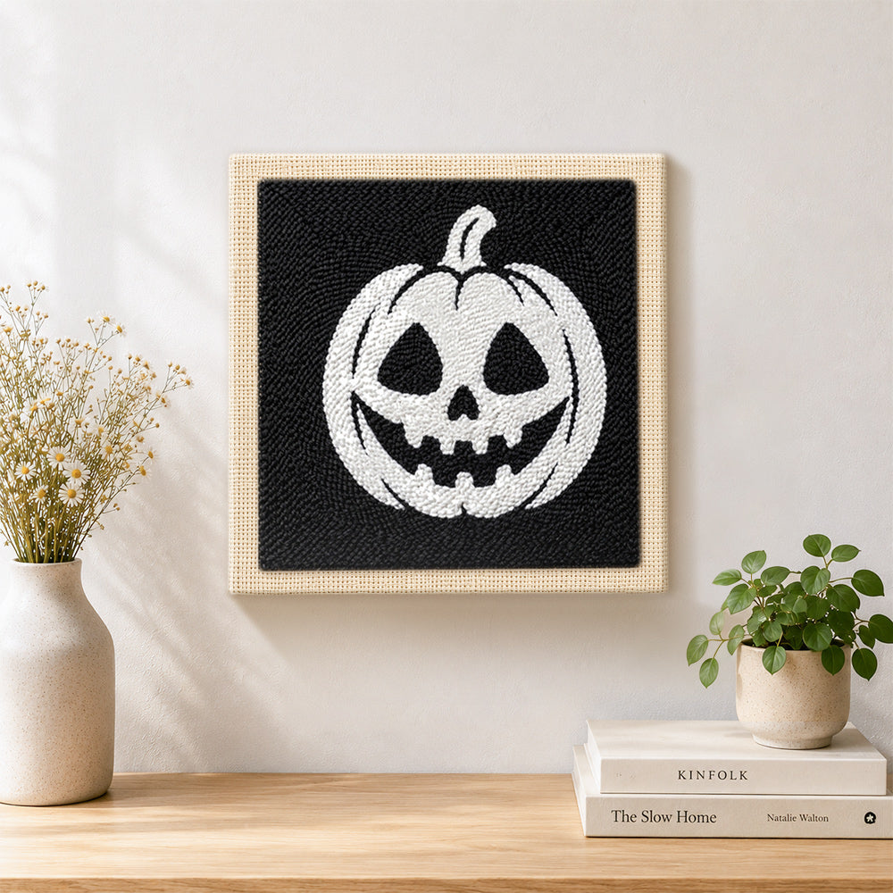 Finished white jack‑o‑lantern artwork displayed on a wall