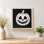 Finished white jack‑o‑lantern artwork displayed on a wall