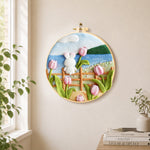 White rabbit on fence with tulips needle felt wall art displayed in a bright home interior