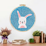 Finished white rabbit with upright ears artwork displayed on a wall