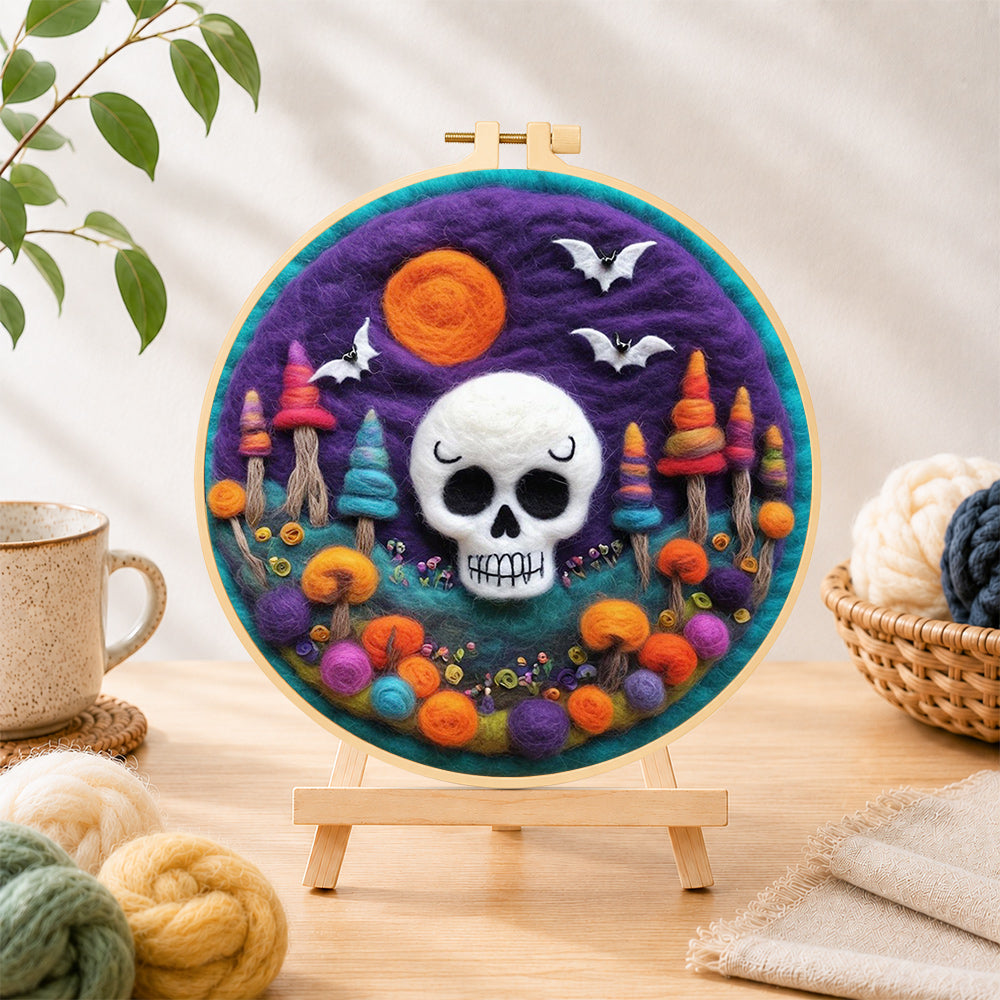 Finished white skull with colorful mushroom trees needle felting displayed on a wooden easel