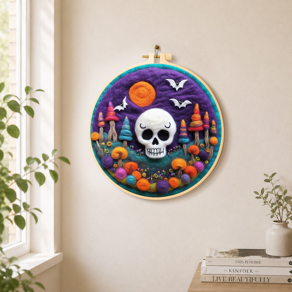 White skull with colorful mushroom trees needle felt wall art displayed in a bright home interior