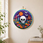 White skull with colorful mushroom trees needle felt wall art displayed in a bright home interior