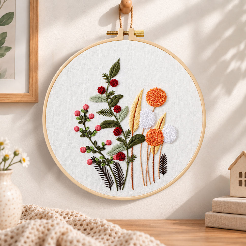 Wild berry and dandelion blooms embroidery hoop wall art displayed as warm and cozy handmade home decor