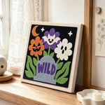 Wild halloween blooms punch needle artwork displayed on a table
