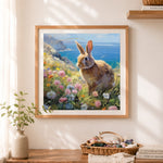 Finished wild rabbit in coastal wildflowers cross stitch artwork displayed as home decor