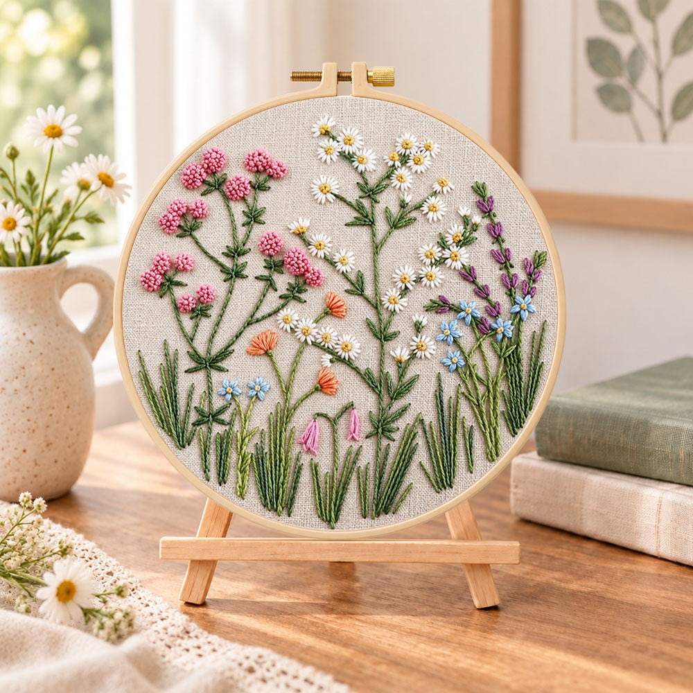 Wildflower blooms embroidery kit finished hoop displayed on a wooden stand as cozy tabletop decor