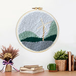 Finished windmill in mountain landscape artwork displayed on a wall