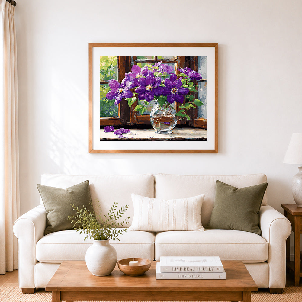 Finished window sill clematis cross stitch artwork displayed as home decor