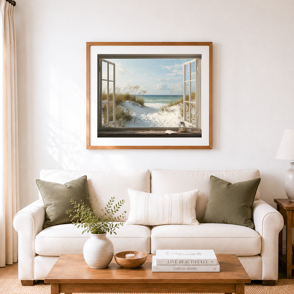 Finished window view of dune grass and calm ocean cross stitch artwork displayed as home decor