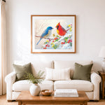 Finished winter birds on snowy branch cross stitch artwork displayed as home decor