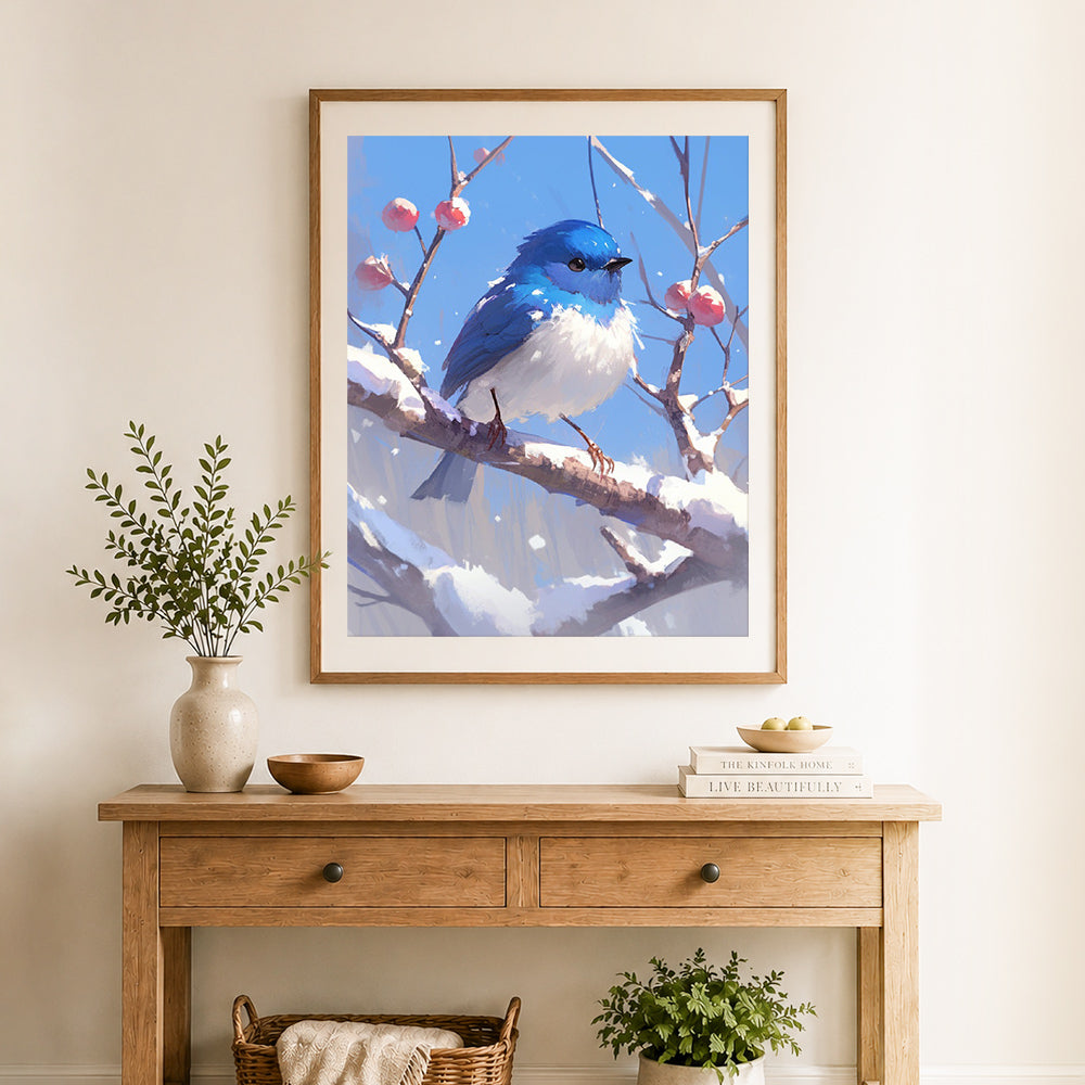 Finished winter blue bird scene cross stitch artwork displayed as home decor