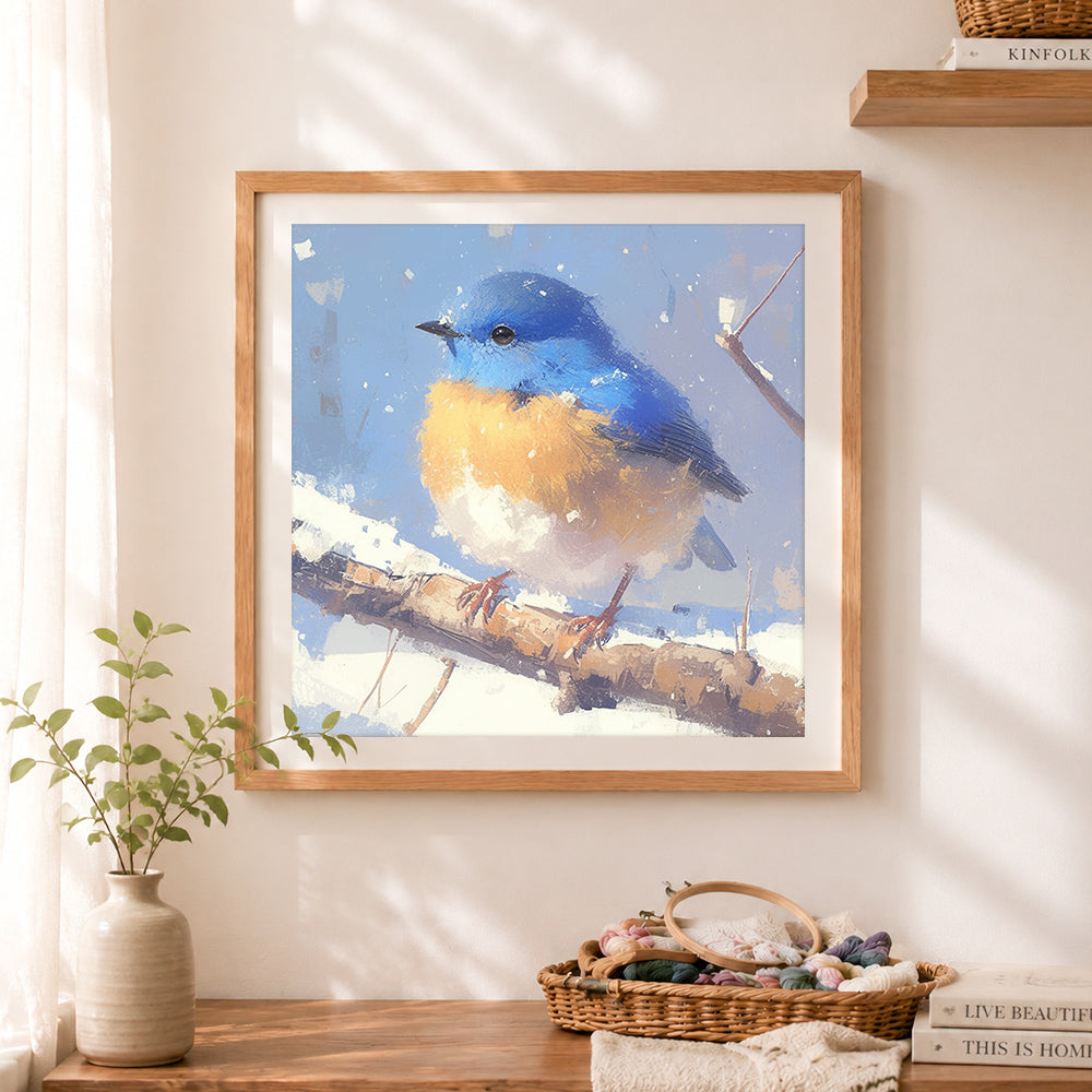 Finished winter bluebird in snow cross stitch artwork displayed as home decor