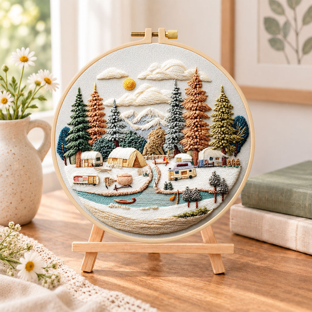 Winter camping valley embroidery kit finished hoop displayed on a wooden stand as cozy tabletop decor