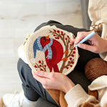 Creating handmade winter cardinal on the berry branch punch needle artwork