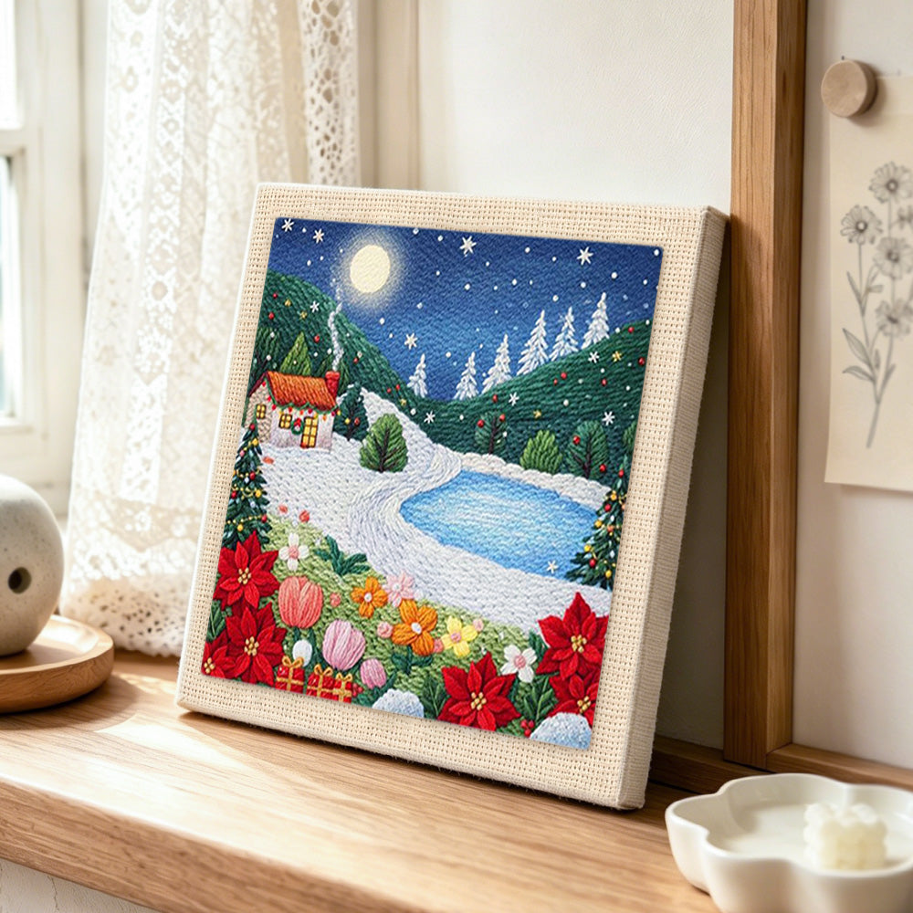 Winter mountain landscape punch needle artwork displayed on a table