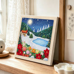 Winter mountain landscape punch needle artwork displayed on a table