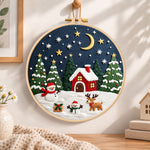 Winter night christmas scene embroidery hoop wall art displayed as warm and cozy handmade home decor