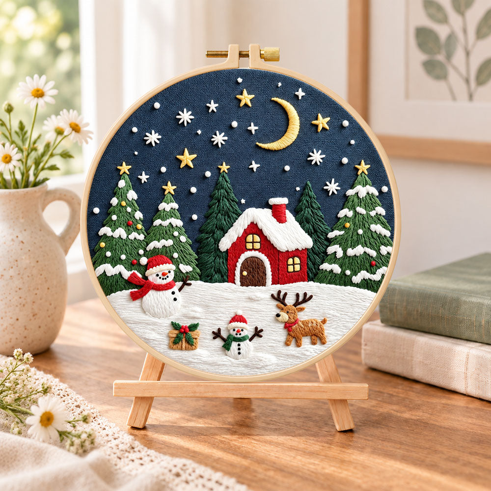 Winter night christmas scene embroidery kit finished hoop displayed on a wooden stand as cozy tabletop decor