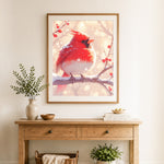 Finished winter red bird on snowy branch cross stitch artwork displayed as home decor
