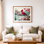 Finished winter red cardinal on snowy berry branch cross stitch artwork displayed as home decor