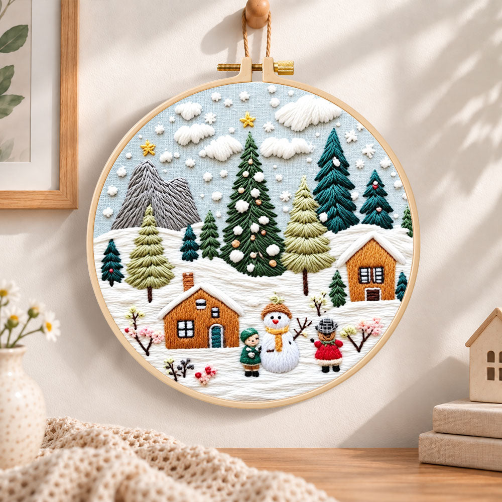 Winter snowy village embroidery hoop wall art displayed as warm and cozy handmade home decor