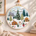 Winter snowy village embroidery hoop wall art displayed as warm and cozy handmade home decor