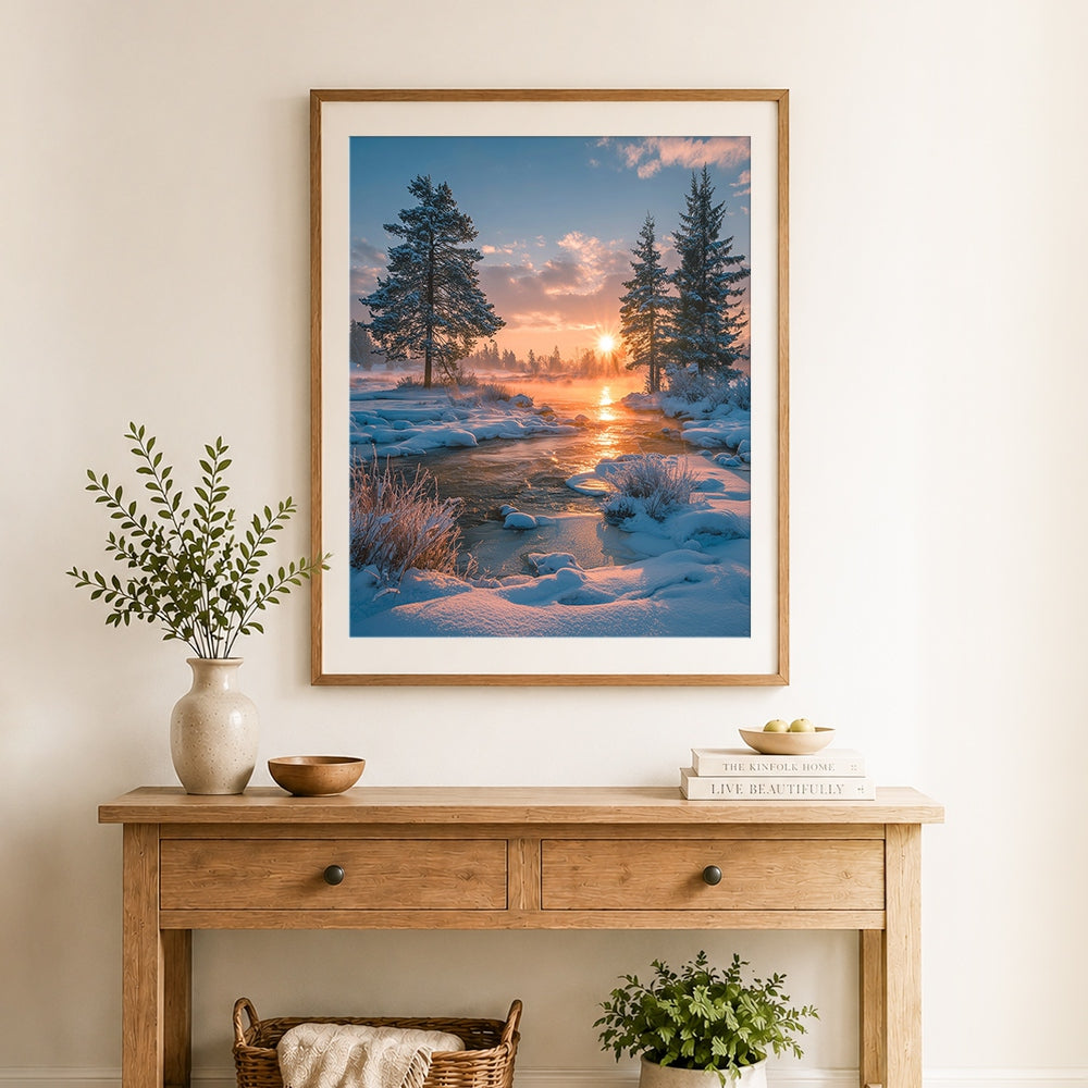 Finished winter sunrise over snowy river with pine trees cross stitch artwork displayed as home decor